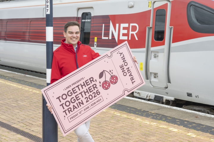 LNER-Community-Partnerships-Manager-next-to-LNER-Azuma-Train-with-giant-ticket-ahead-of-special-Harry-Styles-themed-train-2-scaled.jpg